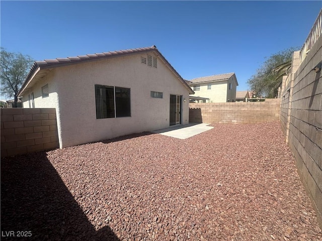 8042 Palace Monaco Ave, Las Vegas, NV 89117 - back of house featuring stucco siding, a fenced backyard, and a patio area