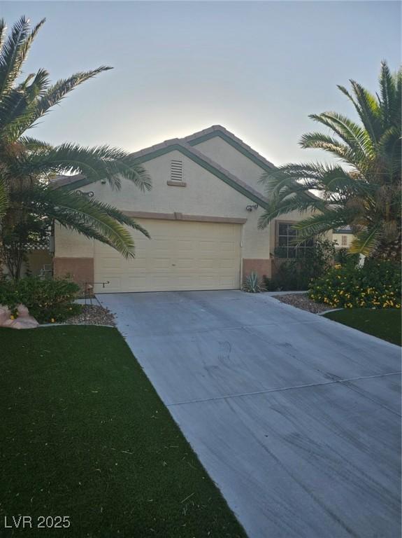 5717 Blizzard Breeze St, North Las Vegas, NV 89081 - view of front of home with concrete driveway, stucco siding, and an attached garage