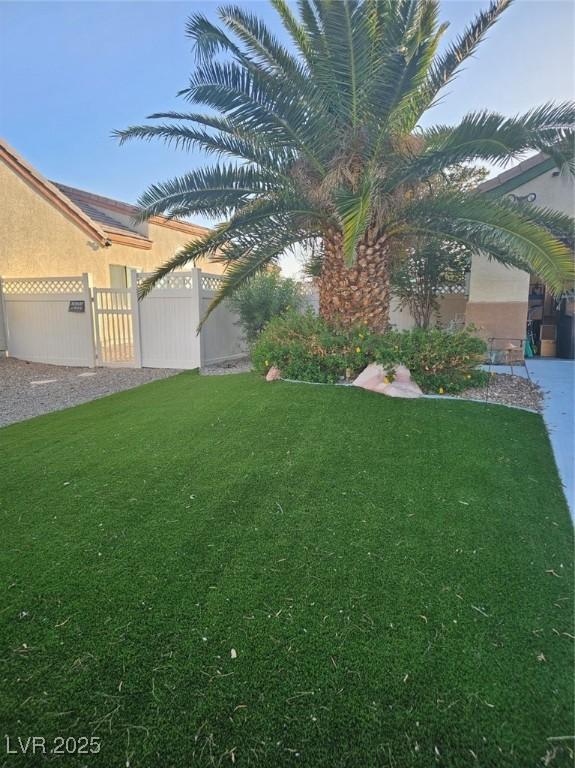 5717 Blizzard Breeze St, North Las Vegas, NV 89081 - view of grassy yard featuring a gate