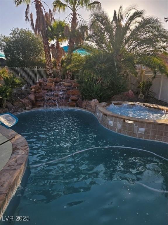 5717 Blizzard Breeze St, North Las Vegas, NV 89081 - view of pool with a fenced backyard and a pool with connected hot tub