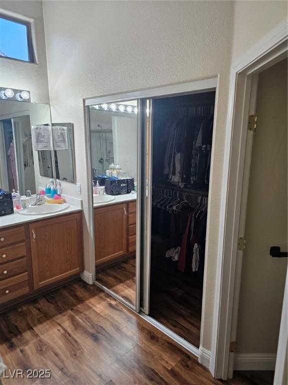 5717 Blizzard Breeze St, North Las Vegas, NV 89081 - bathroom with vanity, wood finished floors, and a spacious closet