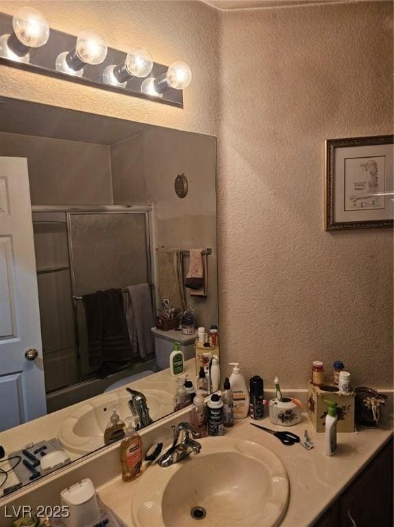 5717 Blizzard Breeze St, North Las Vegas, NV 89081 - full bath with an enclosed shower, a textured wall, and vanity