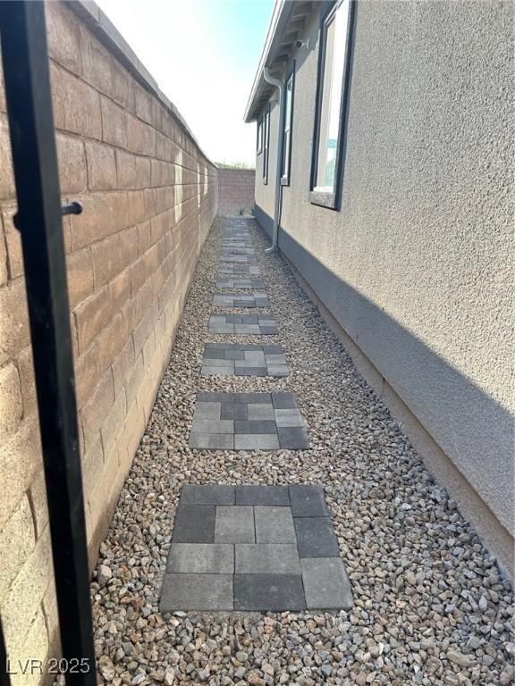 6834 Compass St, North Las Vegas, NV 89084 - view of side of home featuring a fenced backyard