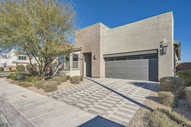 6834 Compass St, North Las Vegas, NV 89084 - view of front of home featuring decorative driveway, stucco siding, and a garage