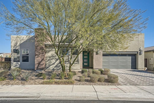 6834 Compass St, North Las Vegas, NV 89084 - view of front of home with stucco siding, driveway, and an attached garage