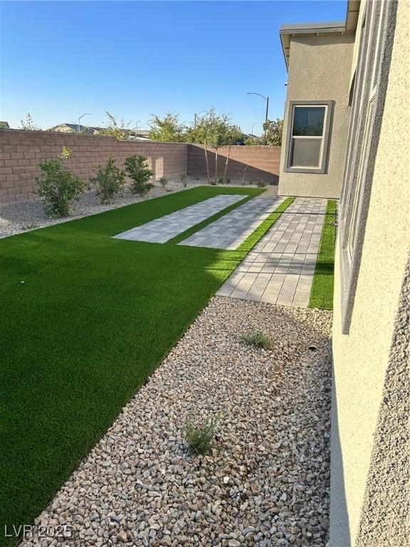 6834 Compass St, North Las Vegas, NV 89084 - fenced backyard featuring a patio