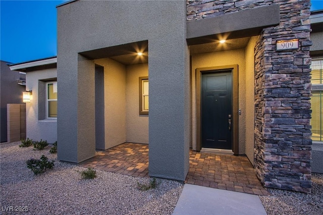 909 Allister Fields Ln, Las Vegas, NV 89138 - doorway to property featuring stucco siding and stone siding