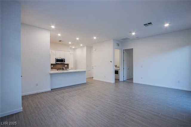 909 Allister Fields Ln, Las Vegas, NV 89138 - unfurnished living room featuring dark wood-type flooring and recessed lighting