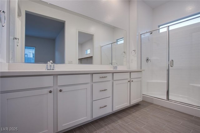 909 Allister Fields Ln, Las Vegas, NV 89138 - full bath with a stall shower, double vanity, plenty of natural light, and wood finished floors