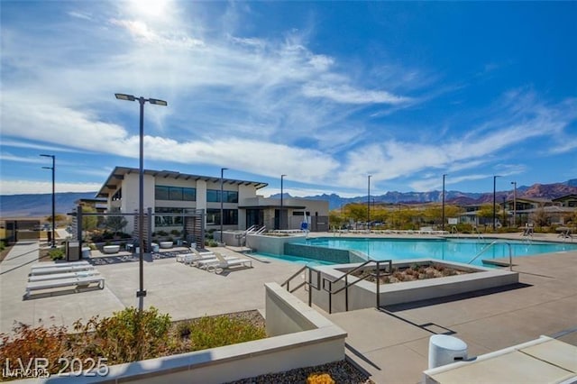 909 Allister Fields Ln, Las Vegas, NV 89138 - community pool featuring a mountain view and a patio area