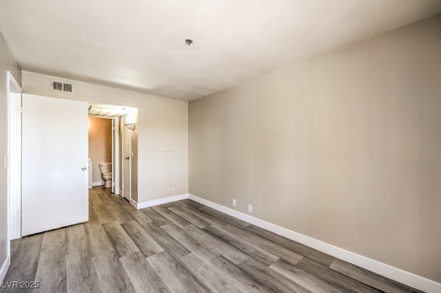 1381 E University Ave Unit 204, Las Vegas, NV 89119 - spare room featuring wood finished floors and a pendent fire sprinkler