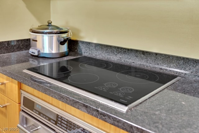 2000 N Fashion Show Dr Unit 2222, Las Vegas, NV 89109 - kitchen view of black electric cooktop and tile countertops