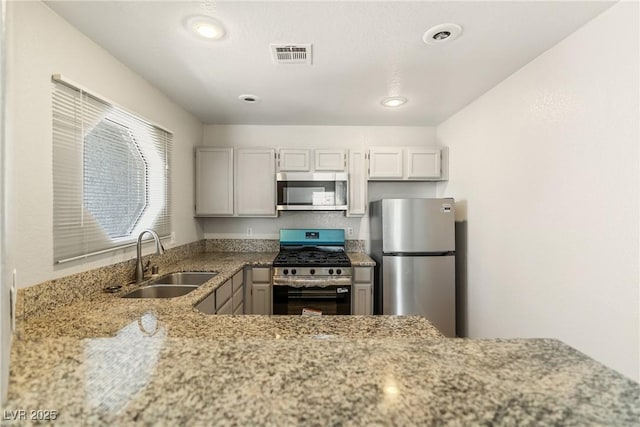 5038 S Rainbow Blvd Unit 206, Las Vegas, NV 89118 - kitchen featuring appliances with stainless steel finishes, light stone countertops, and recessed lighting