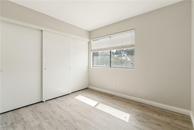 5038 S Rainbow Blvd Unit 206, Las Vegas, NV 89118 - unfurnished bedroom featuring wood finished floors and a closet