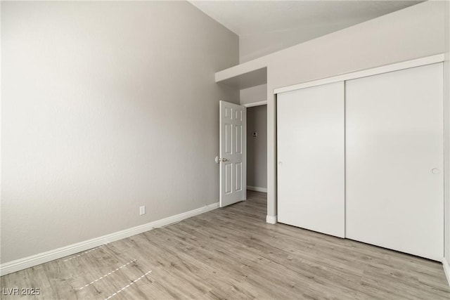 5038 S Rainbow Blvd Unit 206, Las Vegas, NV 89118 - unfurnished bedroom with light wood-type flooring, a closet, and high vaulted ceiling