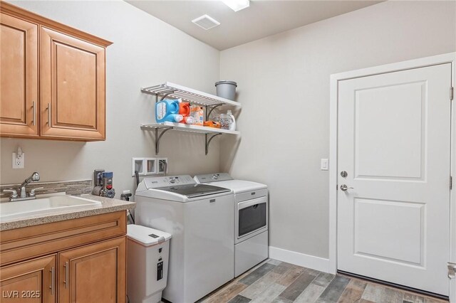 171 Weeping Willow Ct, Pahrump, NV 89048 - laundry room with washer and dryer, light wood-style floors, and cabinet space