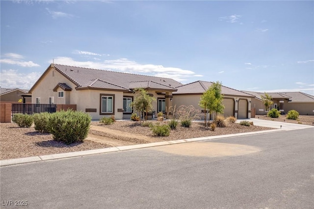 171 Weeping Willow Ct, Pahrump, NV 89048 - view of front facade with stucco siding, an attached garage, concrete driveway, and a tiled roof
