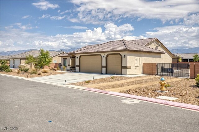 171 Weeping Willow Ct, Pahrump, NV 89048 - ranch-style home with an attached garage, stucco siding, concrete driveway, a mountain view, and a tiled roof