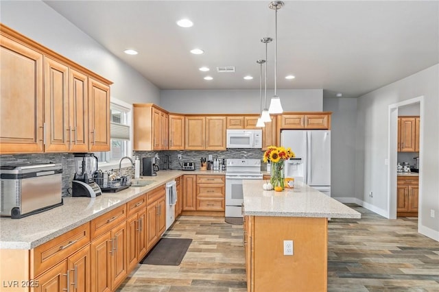 171 Weeping Willow Ct, Pahrump, NV 89048 - kitchen with white appliances, a center island, recessed lighting, tasteful backsplash, and light wood-type flooring