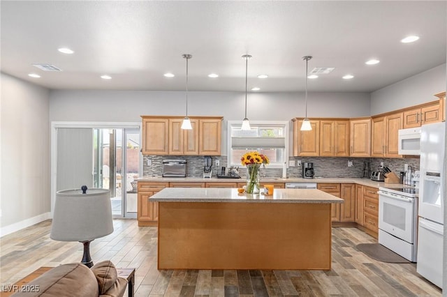 171 Weeping Willow Ct, Pahrump, NV 89048 - kitchen with white appliances, tasteful backsplash, a kitchen island, light wood-style flooring, and recessed lighting