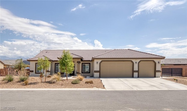 171 Weeping Willow Ct, Pahrump, NV 89048 - mediterranean / spanish house with stucco siding, a garage, concrete driveway, and a tiled roof