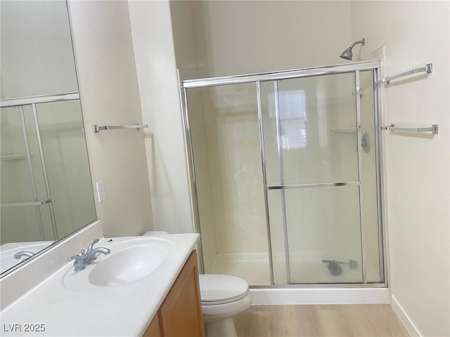 8985 S Durango Dr Unit 2043, Las Vegas, NV 89113 - bathroom featuring a shower stall, vanity, and wood finished floors