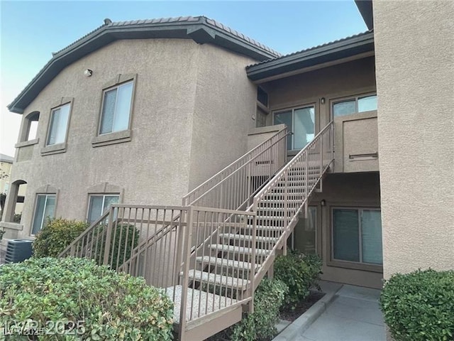 8985 S Durango Dr Unit 2043, Las Vegas, NV 89113 - view of side of home featuring stairs and stucco siding