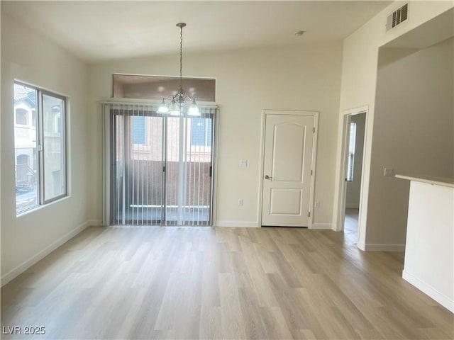 8985 S Durango Dr Unit 2043, Las Vegas, NV 89113 - unfurnished dining area with a chandelier, light wood-style floors, and plenty of natural light
