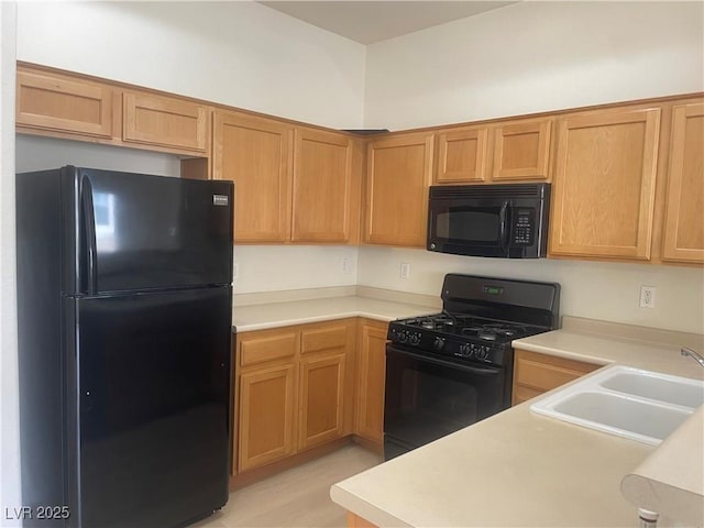 8985 S Durango Dr Unit 2043, Las Vegas, NV 89113 - kitchen featuring black appliances, light countertops, and light wood-type flooring