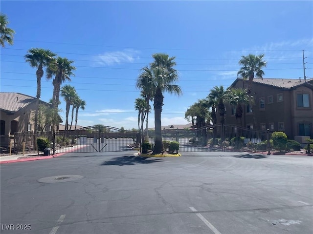 8985 S Durango Dr Unit 2043, Las Vegas, NV 89113 - view of asphalt road with a gate, a gated entry, and curbs