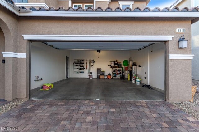 6909 Toll Mountain St, North Las Vegas, NV 89086 - garage featuring decorative driveway