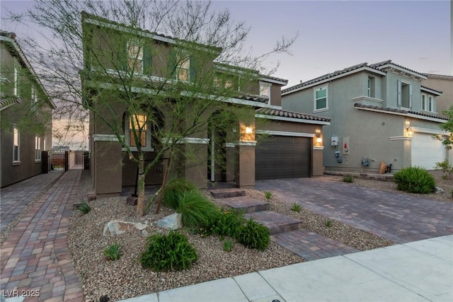6909 Toll Mountain St, North Las Vegas, NV 89086 - view of front of house featuring stucco siding, a garage, driveway, and a tiled roof