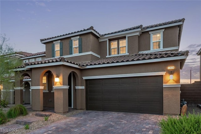 6909 Toll Mountain St, North Las Vegas, NV 89086 - view of front of house featuring an attached garage, stucco siding, driveway, and a tile roof