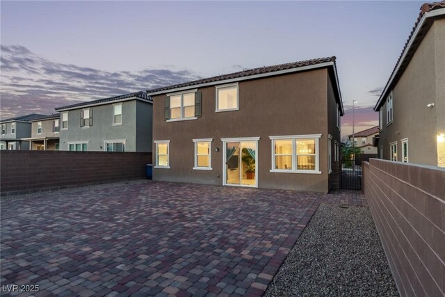 6909 Toll Mountain St, North Las Vegas, NV 89086 - rear view of property featuring stucco siding, a patio area, and a gate
