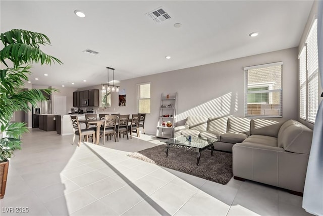 6909 Toll Mountain St, North Las Vegas, NV 89086 - living room featuring recessed lighting, a chandelier, and light tile patterned floors