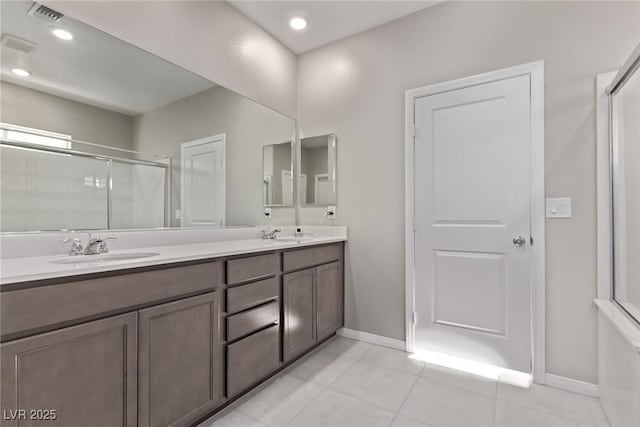 6909 Toll Mountain St, North Las Vegas, NV 89086 - bathroom featuring double vanity, an enclosed shower, and tile patterned floors