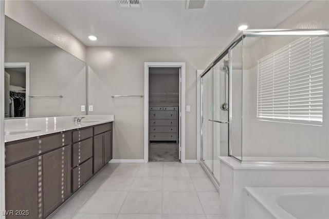 6909 Toll Mountain St, North Las Vegas, NV 89086 - full bath featuring a walk in closet, a shower stall, double vanity, a garden tub, and recessed lighting
