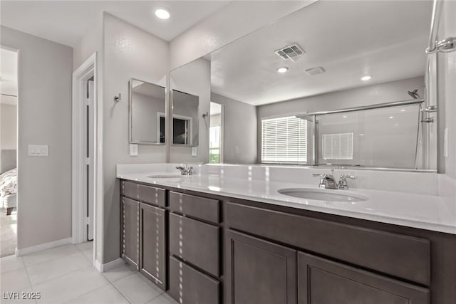 6909 Toll Mountain St, North Las Vegas, NV 89086 - full bathroom featuring double vanity, a shower with door, and tile patterned floors