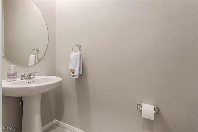 6909 Toll Mountain St, North Las Vegas, NV 89086 - bathroom featuring a sink and baseboards