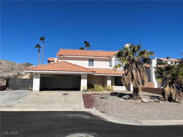 2284 Mesa Canyon Dr, Laughlin, NV 89029 - mediterranean / spanish-style house with stucco siding, a tile roof, a garage, and driveway