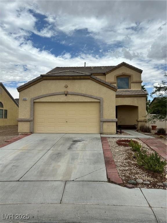 6412 Point Break St, North Las Vegas, NV 89084 - view of front of house featuring driveway, stucco siding, an attached garage, and a tile roof