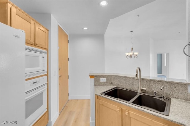 75 E Agate Ave Unit 206, Las Vegas, NV 89123 - kitchen featuring white appliances, light brown cabinets, recessed lighting, a chandelier, and light wood finished floors