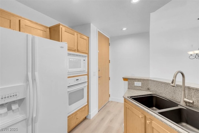 75 E Agate Ave Unit 206, Las Vegas, NV 89123 - kitchen with white appliances, light brown cabinetry, light wood finished floors, recessed lighting, and light countertops