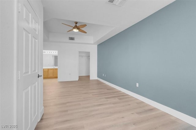 75 E Agate Ave Unit 206, Las Vegas, NV 89123 - unfurnished bedroom with light wood-type flooring, a raised ceiling, a ceiling fan, and a closet