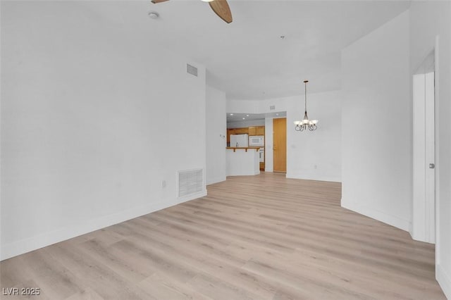 75 E Agate Ave Unit 206, Las Vegas, NV 89123 - unfurnished living room with light wood-type flooring, a ceiling fan, and a chandelier