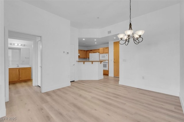 75 E Agate Ave Unit 206, Las Vegas, NV 89123 - unfurnished living room with a chandelier, light wood-style floors, and recessed lighting