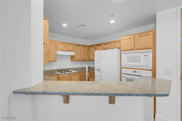 75 E Agate Ave Unit 206, Las Vegas, NV 89123 - kitchen featuring white appliances, under cabinet range hood, light brown cabinets, a kitchen breakfast bar, and recessed lighting
