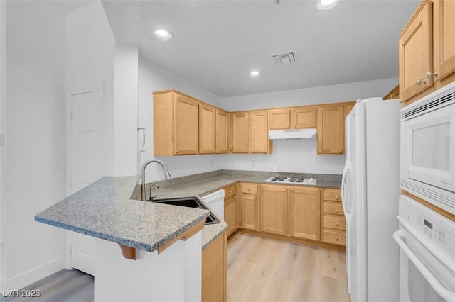 75 E Agate Ave Unit 206, Las Vegas, NV 89123 - kitchen with white appliances, a peninsula, under cabinet range hood, light wood-type flooring, and light brown cabinets