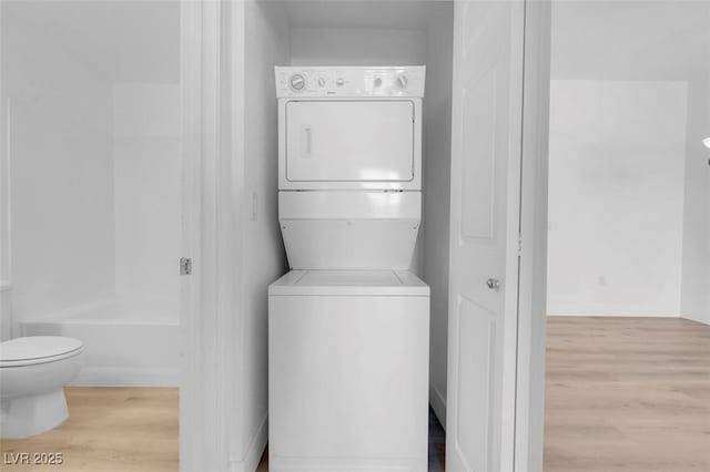 75 E Agate Ave Unit 206, Las Vegas, NV 89123 - laundry area featuring stacked washer and clothes dryer and wood finished floors