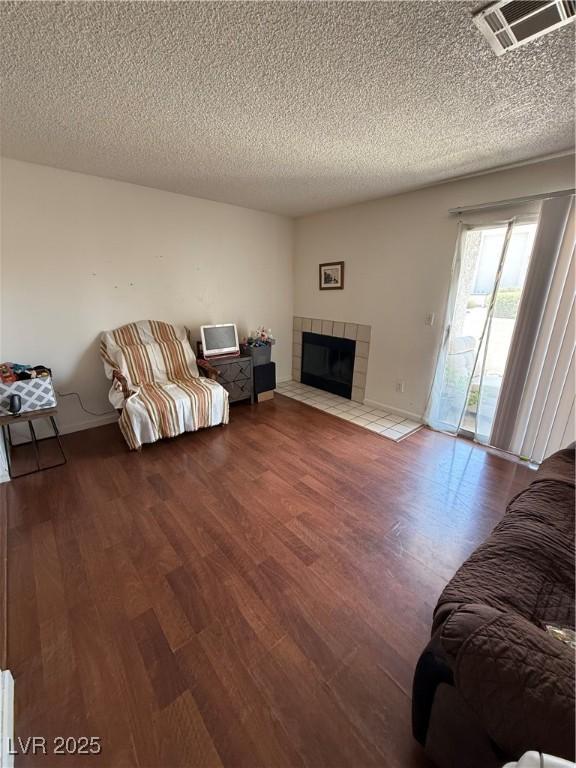 3150 Soft Breezes Dr Unit 1167, Las Vegas, NV 89128 - living area featuring wood finished floors, a fireplace, and a textured ceiling